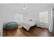 Cozy bedroom with wood floors, a white comforter, and bright natural lighting at 521 Holiday Dr, Summerville, SC 29483
