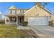 Charming two-story home with a covered front porch, attached garage, and well-maintained landscaping at 521 Holiday Dr, Summerville, SC 29483