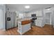 Bright kitchen featuring stainless steel appliances, white cabinetry, and a kitchen island at 521 Holiday Dr, Summerville, SC 29483