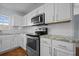 Modern kitchen with stainless steel appliances, granite countertops, and white cabinets at 521 Holiday Dr, Summerville, SC 29483