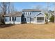Rear exterior view of a two-story home with blue siding, white trim and a screened in porch at 5680 Barbary Coast Rd, Hollywood, SC 29449