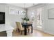 Charming dining area with modern table, stylish chairs, and large windows offering backyard views at 5680 Barbary Coast Rd, Hollywood, SC 29449