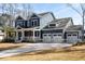 Beautiful two-story home with a three-car garage and a covered porch, perfect for enjoying the outdoors at 5680 Barbary Coast Rd, Hollywood, SC 29449