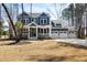 Charming two-story home with blue siding, a front porch, and a three-car garage at 5680 Barbary Coast Rd, Hollywood, SC 29449