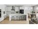 Bright modern kitchen with a large island featuring bar stools, seamlessly flowing into the dining area at 5680 Barbary Coast Rd, Hollywood, SC 29449