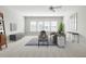 Inviting living room with neutral tones, a cozy sofa, and large windows offering natural light and comfort at 5680 Barbary Coast Rd, Hollywood, SC 29449