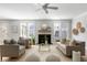 Cozy living room with fireplace, complemented by neutral tones, modern decor, and natural light from large windows at 5680 Barbary Coast Rd, Hollywood, SC 29449