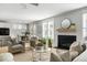 Inviting living room featuring a fireplace, stylish furniture, and seamless transition to the dining area, offering a comfortable space at 5680 Barbary Coast Rd, Hollywood, SC 29449