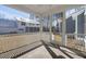 Screened-in porch with white railing, overlooking the backyard and neighboring house at 5680 Barbary Coast Rd, Hollywood, SC 29449