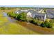 Scenic aerial view of the neighborhood, featuring lush greenery and waterways at 591 Mclernon Trace, Johns Island, SC 29455