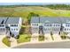 An aerial view of the townhome community showcasing well-manicured lawns and gray roofs at 591 Mclernon Trace, Johns Island, SC 29455