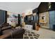 Finished basement area with a leather couch, workout equipment, and sports decor at 591 Mclernon Trace, Johns Island, SC 29455