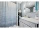 Clean bathroom with a shower, stacked towels, and a modern vanity with ample lighting at 591 Mclernon Trace, Johns Island, SC 29455