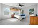 Spacious bedroom with natural light from windows, ceiling fan, and hardwood shelf at 591 Mclernon Trace, Johns Island, SC 29455