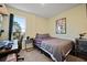 Bedroom with desk, window, and a bed with patterned bedding and a view outside at 591 Mclernon Trace, Johns Island, SC 29455