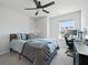 Bright bedroom with a ceiling fan, desk, and large windows for natural light at 591 Mclernon Trace, Johns Island, SC 29455