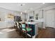 Bright kitchen boasts gray cabinets, stainless steel appliances, and an island with bar stool seating at 591 Mclernon Trace, Johns Island, SC 29455