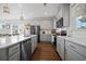 Open kitchen showcasing stainless steel appliances, gray cabinets, and a large island at 591 Mclernon Trace, Johns Island, SC 29455