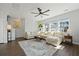 Cozy living room featuring a plush sectional sofa, modern ceiling fan, and ample natural light at 591 Mclernon Trace, Johns Island, SC 29455