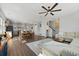 Open-concept living area with hardwood floors, a modern ceiling fan, and plentiful sunlight at 591 Mclernon Trace, Johns Island, SC 29455