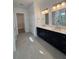 Bathroom vanity with dual sinks, framed mirrors, and tiled flooring at 631 Marsh Cove Cir, Summerville, SC 29486
