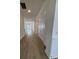 Hallway featuring wood-look floors, white walls, and recessed lighting creating a modern, clean look at 631 Marsh Cove Cir, Summerville, SC 29486