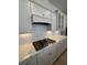 Kitchen counter features white cabinets, subway tile backsplash, and a gas cooktop adding warmth and character at 631 Marsh Cove Cir, Summerville, SC 29486