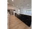 Large kitchen island with modern pendant lights and a contrasting base adding functionality to the stylish design at 631 Marsh Cove Cir, Summerville, SC 29486