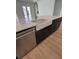Island with white farmhouse sink, stainless steel dishwasher, and countertops with marble effect at 631 Marsh Cove Cir, Summerville, SC 29486