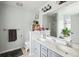 Bright bathroom with double sinks, decorative mirror, and a large window for natural light at 642 Bridlewood Ln, Mount Pleasant, SC 29466