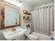 Charming bathroom features a pedestal sink with wood framed mirror, and a shower-tub combo with decorative curtain at 642 Bridlewood Ln, Mount Pleasant, SC 29466