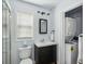 This well-lit bathroom includes a toilet, sink, mirror, and convenient washer/dryer at 642 Bridlewood Ln, Mount Pleasant, SC 29466