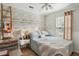 Cozy bedroom features a modern ceiling fan, wood accent wall and lots of natural light at 642 Bridlewood Ln, Mount Pleasant, SC 29466