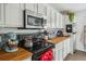 Kitchen features butcher block countertops, subway tile backsplash, white cabinetry, and stainless steel appliances at 642 Bridlewood Ln, Mount Pleasant, SC 29466