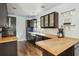 Well-lit kitchen boasts butcher block counters, dark cabinets, and modern stainless steel appliances at 642 Bridlewood Ln, Mount Pleasant, SC 29466