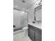 Modern bathroom features a glass enclosed shower and gray vanity with bright white countertops and tile flooring at 668 Ferry St, Mount Pleasant, SC 29464