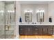 Elegant bathroom featuring double vanity, marble countertop, stylish lighting, and glass-enclosed shower at 668 Ferry St, Mount Pleasant, SC 29464