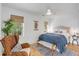 Cozy bedroom featuring ample lighting, a bed with decorative pillows, and hardwood floors at 668 Ferry St, Mount Pleasant, SC 29464
