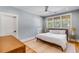 Cozy bedroom featuring light blue walls, a ceiling fan, and a full bed with decorative pillows at 668 Ferry St, Mount Pleasant, SC 29464