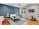 Stylish bedroom featuring blue accent wall, modern decor, and a window with blinds at 668 Ferry St, Mount Pleasant, SC 29464
