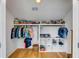 Spacious closet with shelving and hanging rods, filled with clothes and storage containers at 668 Ferry St, Mount Pleasant, SC 29464
