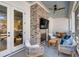 Relaxing covered patio with a brick fireplace and comfortable seating area at 668 Ferry St, Mount Pleasant, SC 29464