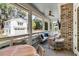 Inviting covered patio with outdoor seating, ceiling fan, and brick fireplace at 668 Ferry St, Mount Pleasant, SC 29464