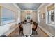 Elegant dining room featuring a large table, decorative wallpaper, and natural light from two windows at 668 Ferry St, Mount Pleasant, SC 29464