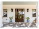 Inviting front entry showcasing a wood door with glass inserts, stylish sconces, and decorative plants at 668 Ferry St, Mount Pleasant, SC 29464
