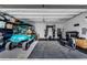 Spacious garage featuring an aqua golf cart and home gym with weights and a rowing machine at 668 Ferry St, Mount Pleasant, SC 29464