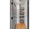 Hallway with built-in bookshelves, hardwood floors, and gray trim and doors at 668 Ferry St, Mount Pleasant, SC 29464