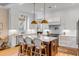 Bright kitchen featuring white cabinets, a marble island with seating, and modern pendant lighting at 668 Ferry St, Mount Pleasant, SC 29464