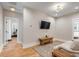 Bright living room with a modern TV, wood accent table, and a patterned area rug at 668 Ferry St, Mount Pleasant, SC 29464