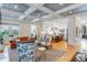 Open-concept living room flows into kitchen with light wood floors, decorative ceiling, and comfortable seating at 668 Ferry St, Mount Pleasant, SC 29464
